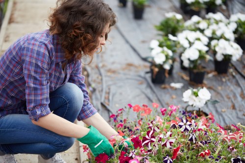 Gardener at work in a Bethnal Green garden, preparing tools